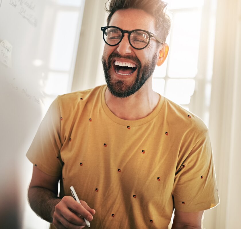 Man with glasses laughing
