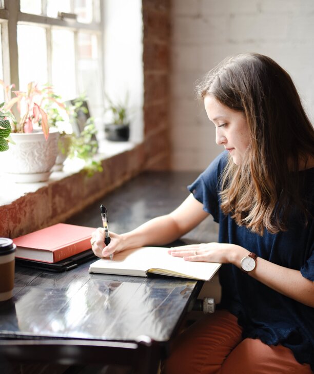 Woman writing in a journal