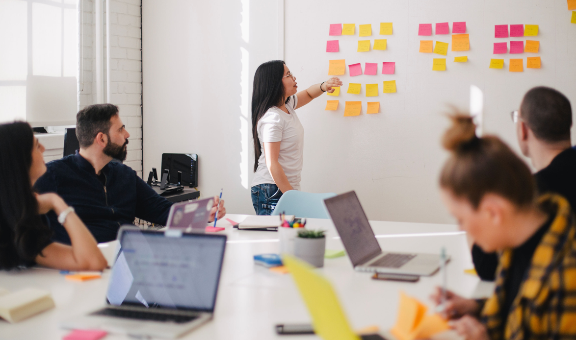 Woman leading a meeting at a whiteboard